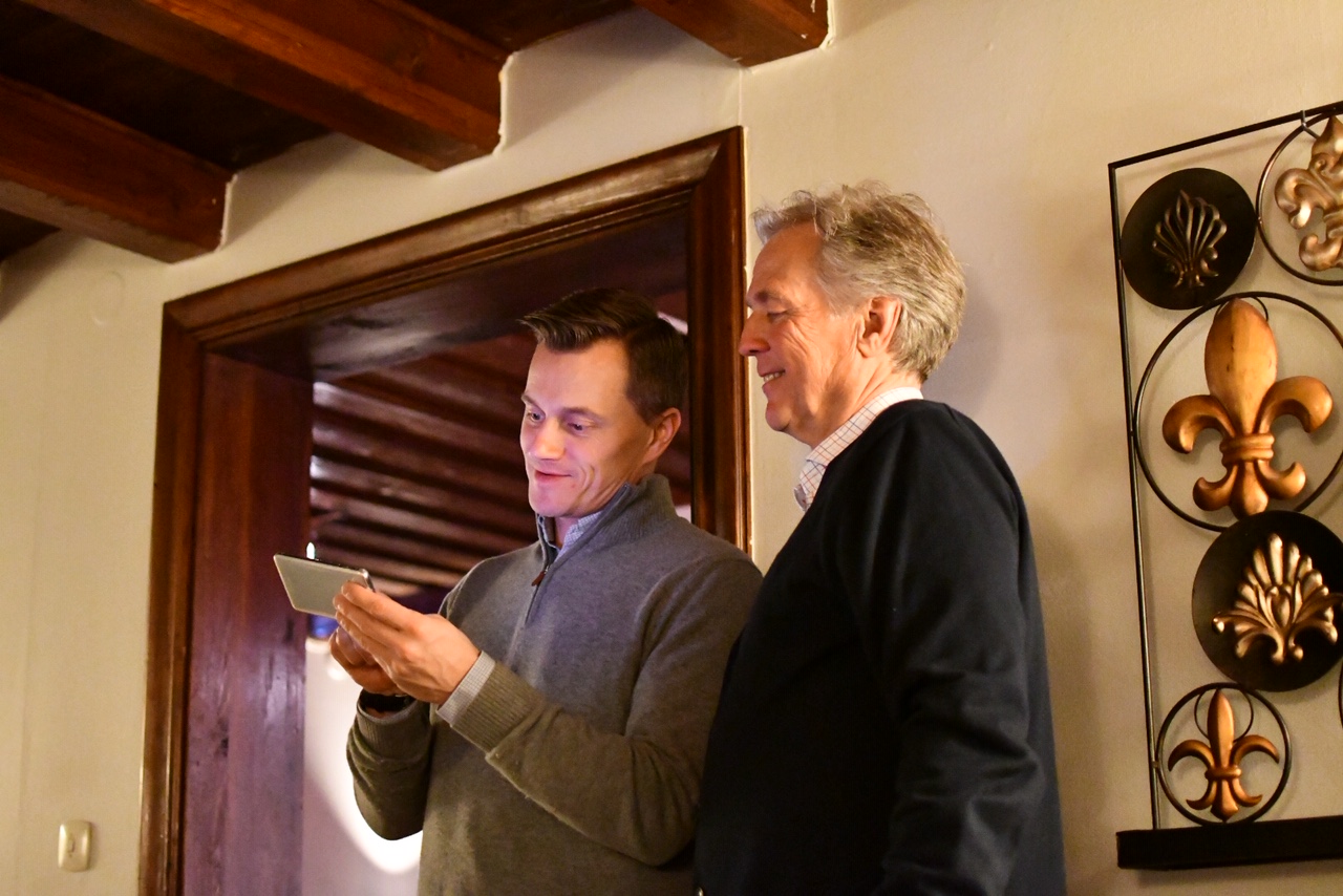 2 men looking at a mobile screen
