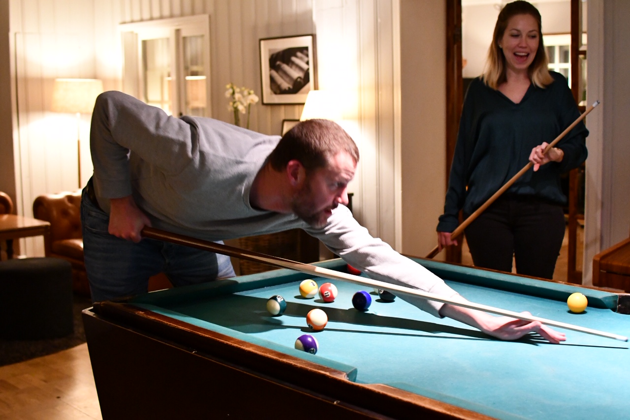 2 persons playing pool