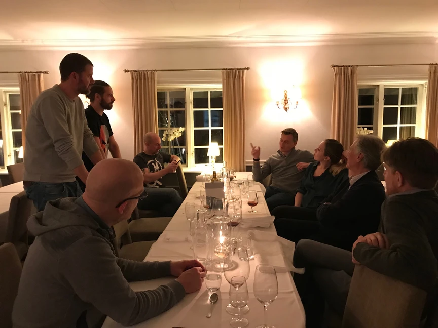 Many people discussing at a dinner table