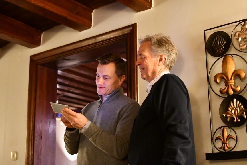 2 men looking at a mobile screen