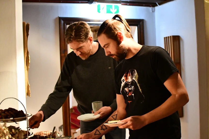 2 persons admiring cakes