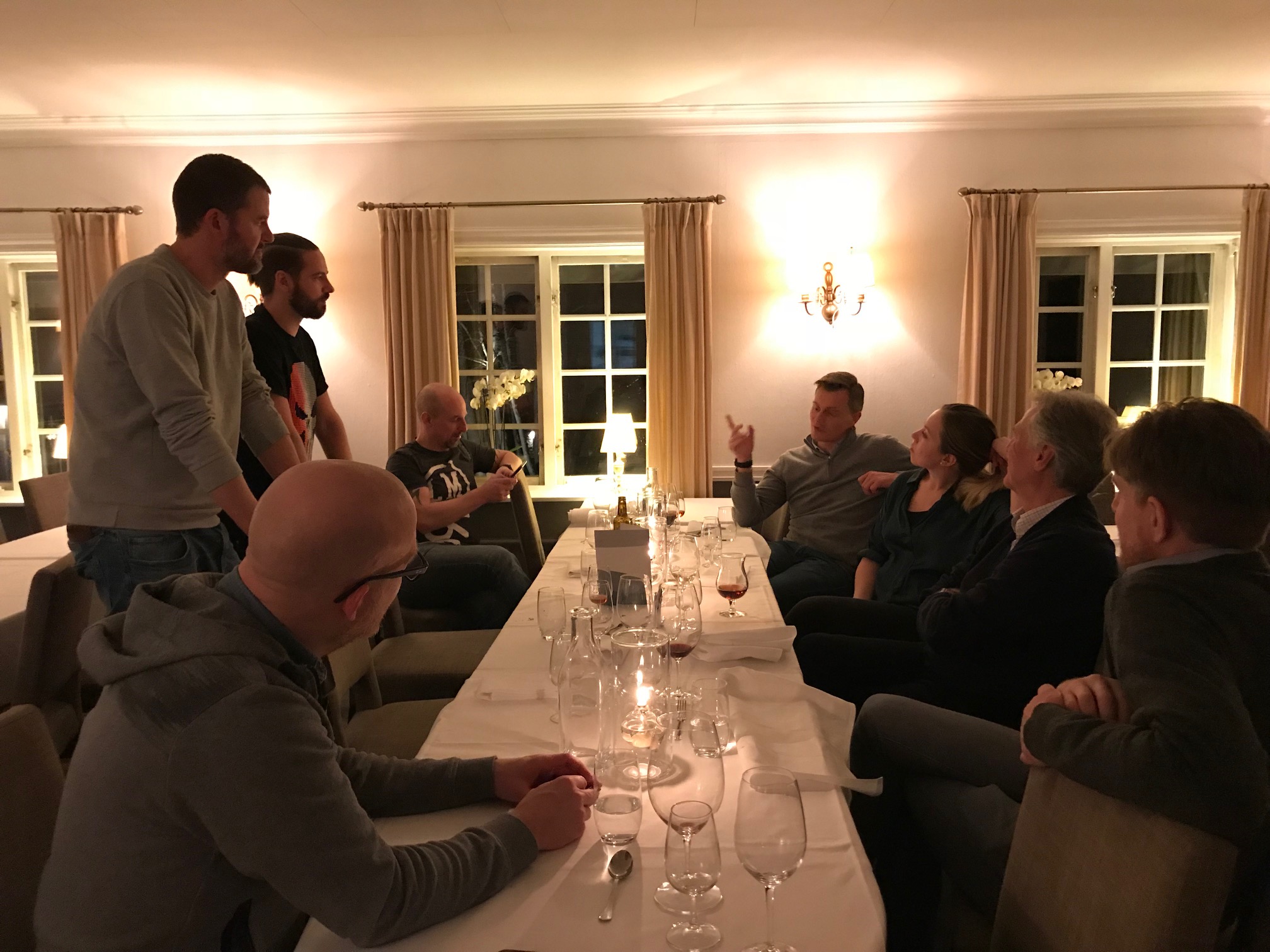 Many people discussing at a dinner table