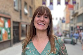 Christine i gatumiljö med ett stort leende