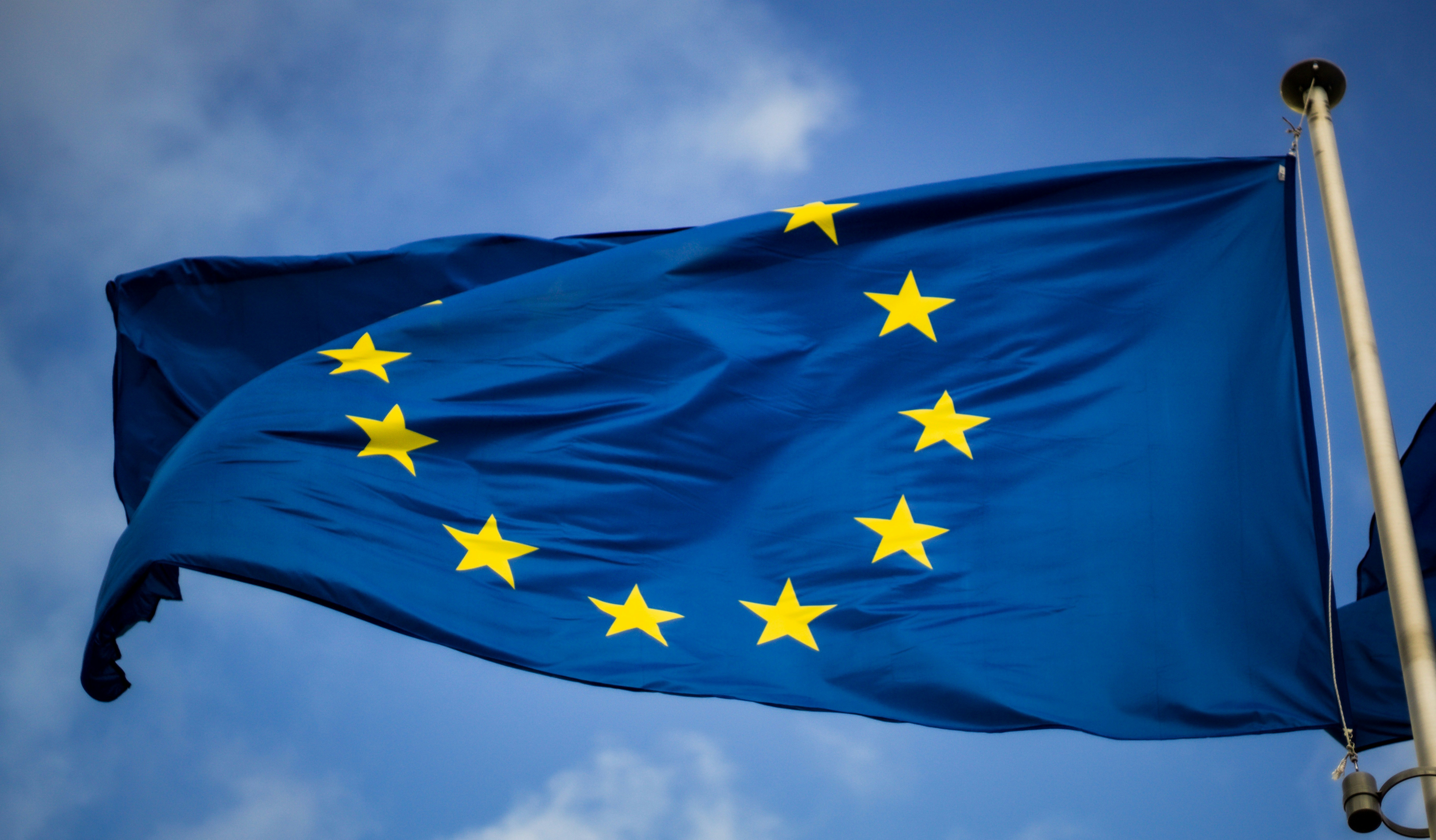 Blue and yellow starflag with blue sky behind