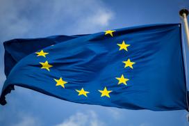Blue and yellow starflag with blue sky behind