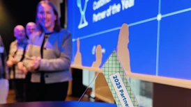 Many people in a row smiling and toasting