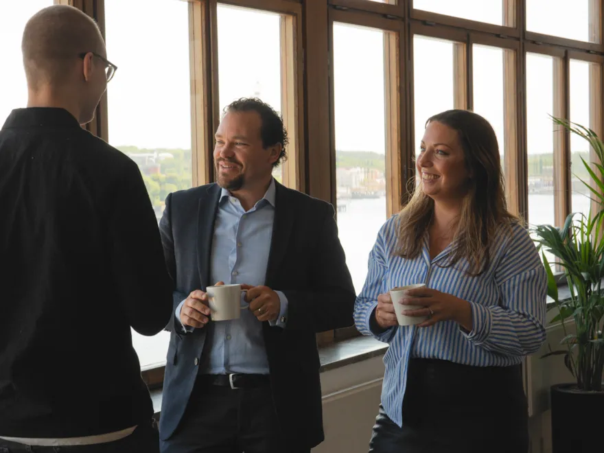 Happy employees chatting during a coffee break.