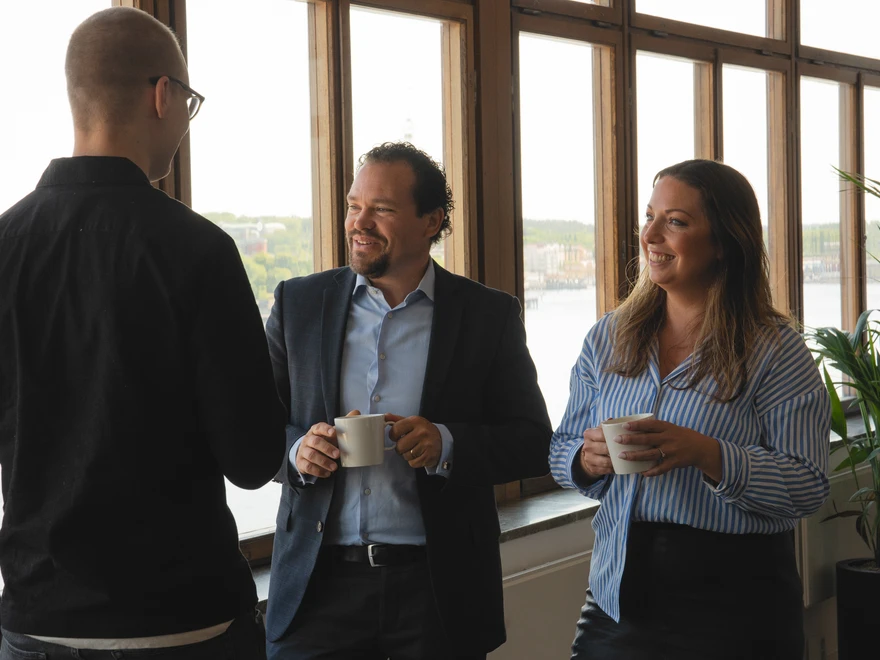 Happy employees chatting during a coffee break.