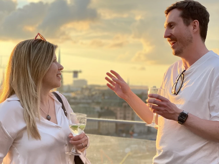 Two people conversing on a roof terrace