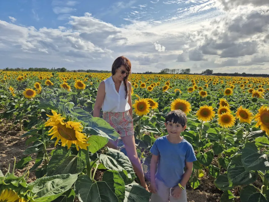 Christine with her son in a sunflower field