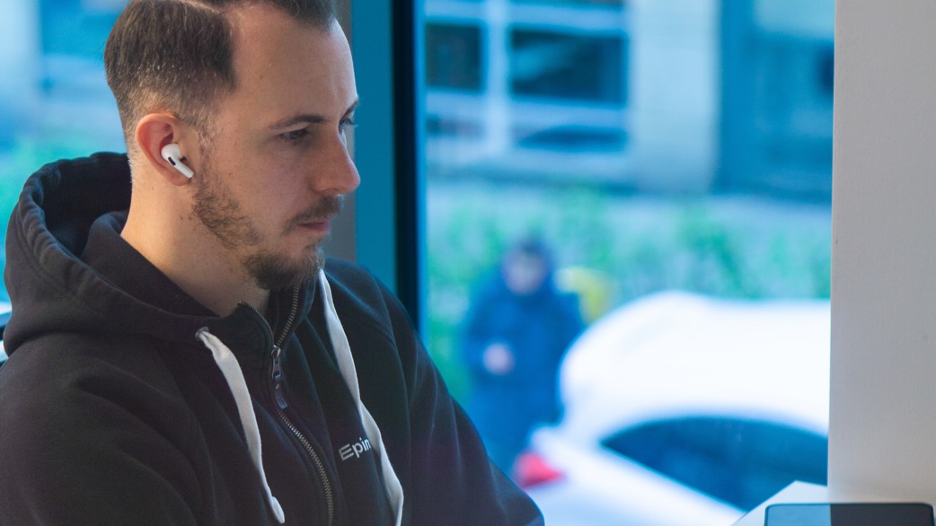 Piotr infront of a computer