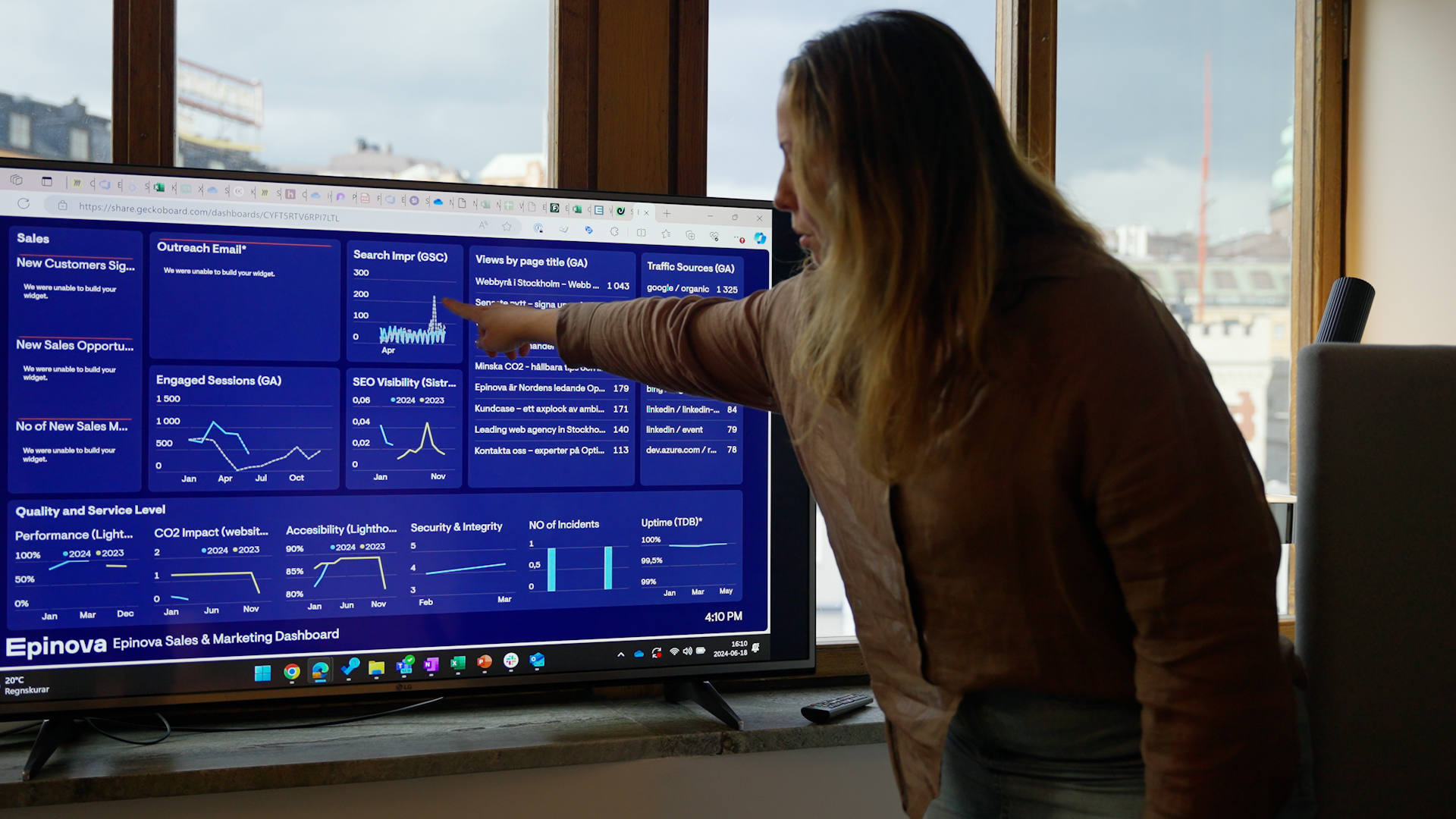 Woman pointing at statistics on screen