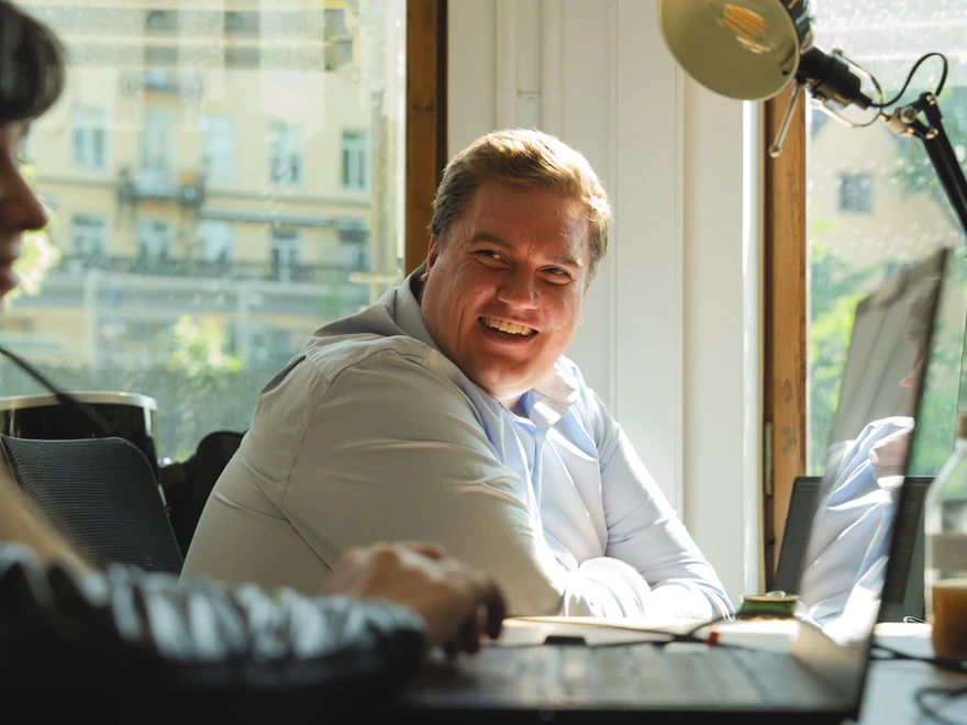 Two people conversing at desk