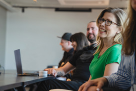 Happy people at a table in a conference room
