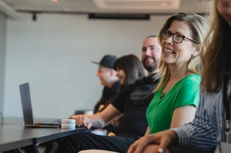 Happy people at a table in a conference room