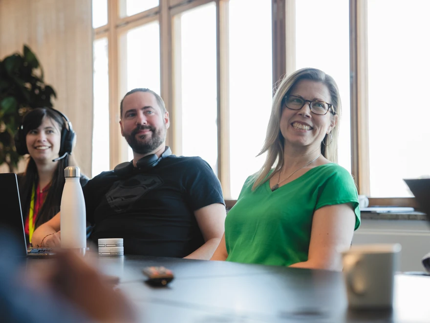 Three people in a meeting room