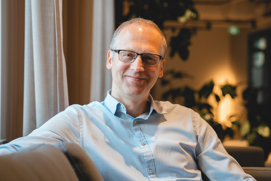 Man in glasses smiling at camera