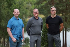 Joacim, Erik and Kalle outdoors with trees and water in the background