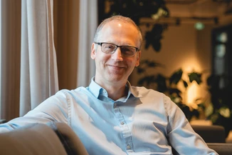 Man in glasses smiling at camera