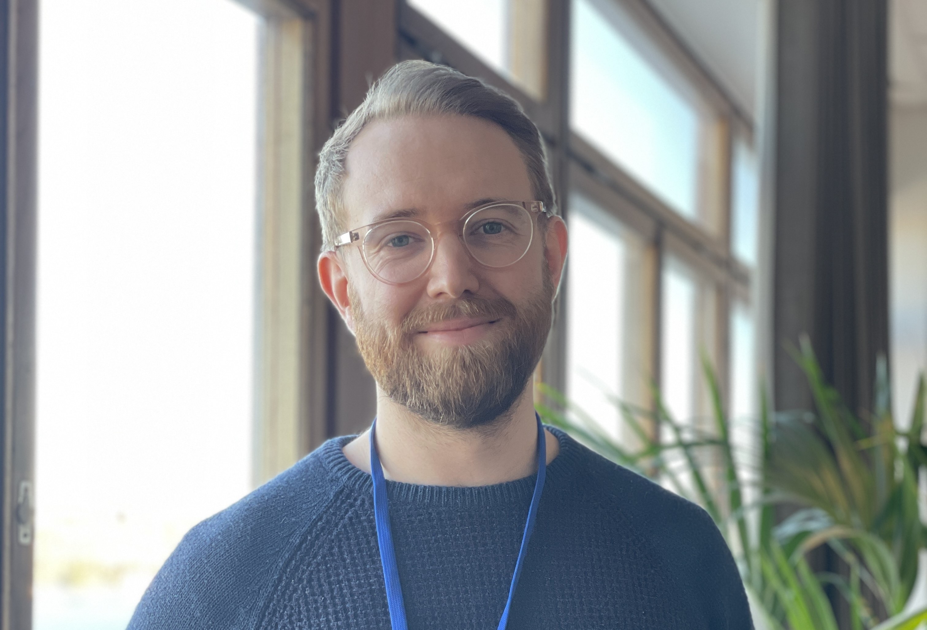 Joel in front of the window of Epinova's office