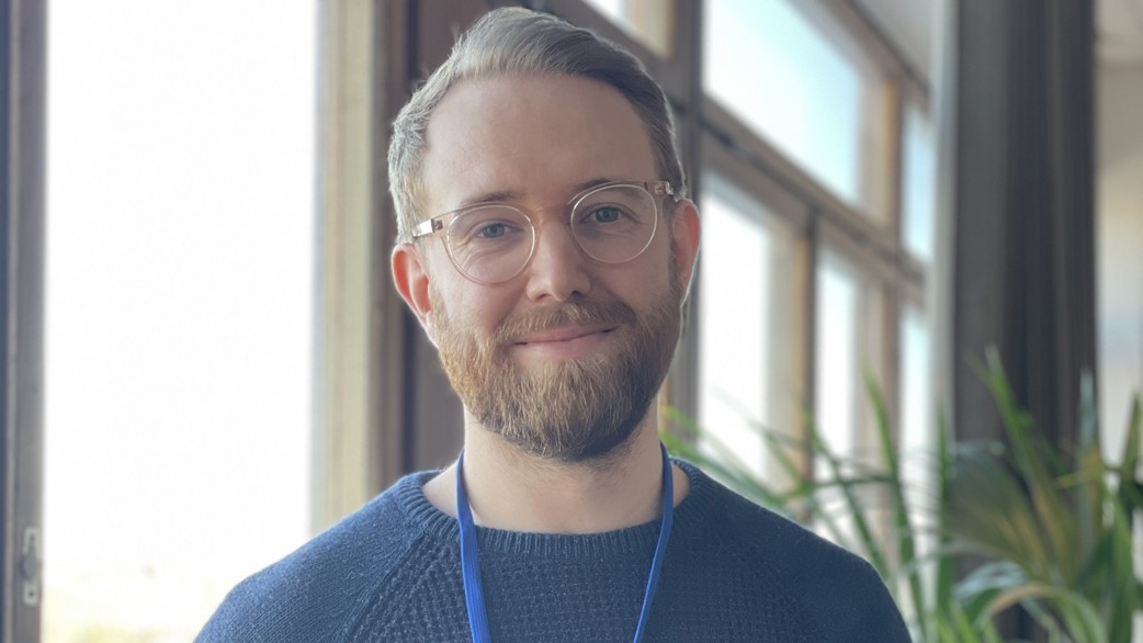 Joel in front of the window of Epinova's office