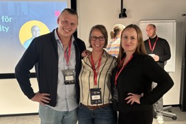 Three people at the SEO event are facing the camera