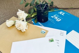 Letters and parcels on a tabel with flowers